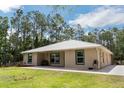 Charming single-story home with green framed windows, metal roof, and a well-maintained lawn at 723 River Run Rd, Osteen, FL 32764