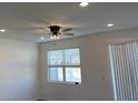 Well-lit bedroom with a ceiling fan, recessed lights, and a window providing natural light and a view at 741 Spring Palms Loop, Orlando, FL 32828