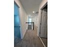 Upstairs hallway with neutral carpet, leading to bedrooms and bathrooms with white doors at 741 Spring Palms Loop, Orlando, FL 32828