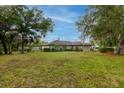 Expansive, well-maintained yard with mature trees offers ample space for outdoor activities and serene views at 789 Barger Dr, Deltona, FL 32738