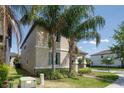 Corner lot featuring verdant lawn, complemented by tropical palms, and attractive exterior details at 7931 Rock Dove Dr, Winter Garden, FL 34787
