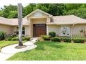 Home with a welcoming double door entrance, lush landscaping, and a cozy ambiance at 812 Silverwood Dr, Lake Mary, FL 32746