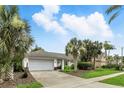 Attractive single-story home featuring mature palm trees, green lawn, and convenient two-car garage at 826 Bright Meadow Dr, Lake Mary, FL 32746