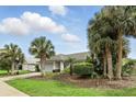 Landscaped single-story home with palm trees, well-maintained lawn, and a two-car garage with driveway at 826 Bright Meadow Dr, Lake Mary, FL 32746