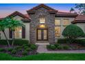 Charming home with stone facade, decorative windows, and meticulously maintained landscaping at 914 Sweetgum Valley Pl, Lake Mary, FL 32746