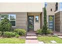 Close-up of townhouse entrances with brick walkways and detailed landscaping at 9820 Bucklow Hill Dr, Orlando, FL 32832