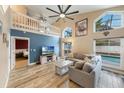Bright living room boasts vaulted ceilings, a ceiling fan, and an adjacent pool view at 1010 Sugarberry Trl, Oviedo, FL 32765
