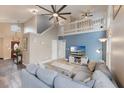 Comfortable living room with a fan, loft, and views of the front door at 1010 Sugarberry Trl, Oviedo, FL 32765