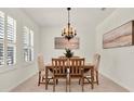 Elegant dining room featuring a wooden table with upholstered chairs and a decorative chandelier at 112 Overton Gardens Lane, Deland, FL 32724
