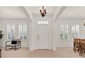 Bright, naturally lit foyer with light tile flooring, chair rail, and white shutters at 112 Overton Gardens Lane, Deland, FL 32724