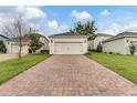 Long brick driveway leads to a detached two-car garage at 11386 Biography Way, Orlando, FL 32832