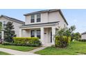 Inviting two-story home with a lush front yard and charming curb appeal at 11386 Biography Way, Orlando, FL 32832