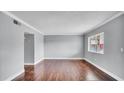 Spacious living room featuring wood floors, natural light, and neutral paint at 115 Oyster Bay Cir # 260, Altamonte Springs, FL 32701