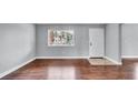 Bright living room boasts gorgeous hardwood floors and a large window for ample sunlight at 115 Oyster Bay Cir # 260, Altamonte Springs, FL 32701