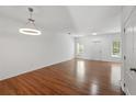 Bright living room with hardwood floors, neutral walls, and a modern light fixture at 13329 Harbor Shore Ln, Winter Garden, FL 34787