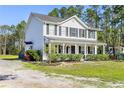Attractive home with a welcoming front porch and lush greenery, ideal for a relaxed lifestyle at 1555 Seminole Run Rd, Osteen, FL 32764