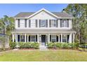 Inviting two-story home featuring a classic design, covered porch, and beautiful curb appeal at 1555 Seminole Run Rd, Osteen, FL 32764