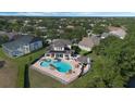 An overhead view of a home with an inviting backyard including a pool, spa, cabana, and outdoor kitchen at 1710 Bridgets Ct, Kissimmee, FL 34744