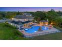Inviting backyard with a large pool, spa, cabana, and outdoor kitchen perfect for twilight entertaining at 1710 Bridgets Ct, Kissimmee, FL 34744