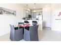Cozy dining area adjacent to the kitchen with seating for four and modern decor at 1802 Coriander Dr, Kissimmee, FL 34759