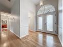 Entryway with hardwood floors and a decorative front door at 1869 Eagles Rest Dr, Apopka, FL 32712