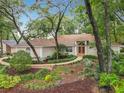 Beautiful home with mature trees and lush landscaping at 1869 Eagles Rest Dr, Apopka, FL 32712