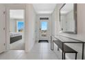 Bright and airy entryway with a glass-paneled door, light tile flooring, and a sleek console table at 203 Taylor Groves Dr, Lake Wales, FL 33853