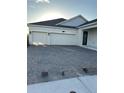 A spacious two-car garage and brick-paved driveway enhance this home's curb appeal at 3084 Ella Way, St Cloud, FL 34771