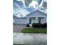 Charming home featuring a two-car garage, stone accents, and well-maintained landscaping at 3084 Ella Way, St Cloud, FL 34771