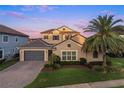 A two-story home features a three-car garage, a tile roof, and lush landscaping in a suburban setting at 3647 Farm Bell Pl, Lake Mary, FL 32746