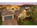 A well-manicured home displays a tiled roof, a spacious three-car garage, and brick paver driveway at 3647 Farm Bell Pl, Lake Mary, FL 32746