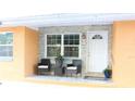 Welcoming front porch with stone accents, comfortable seating, and a bright white front door at 3713 N Econlockhatchee Trl, Orlando, FL 32817