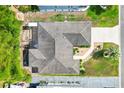 Aerial view showcases the layout of a well maintained home with lush garden, patio, and concrete driveway at 428 Tarrson Blvd, Lady Lake, FL 32159