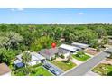 Overhead shot of a home surrounded by lush greenery, showcasing its position within a verdant, wooded neighborhood at 428 Tarrson Blvd, Lady Lake, FL 32159