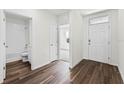 Inviting entryway with dark wood-look flooring leading to an open floor plan and bathroom at 5210 Marshelder, Apopka, FL 32712