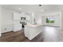 Modern kitchen featuring stainless steel appliances, white cabinetry and a center island at 5210 Marshelder, Apopka, FL 32712