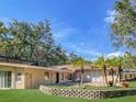 The backyard features a fountain, small palm trees, and block garden wall at 530 Webster St, Lake Mary, FL 32746