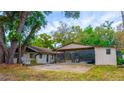 Exterior shot of a home's backyard with screened in porch and covered patio at 530 Webster St, Lake Mary, FL 32746