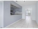 Kitchen featuring granite countertops and stainless steel appliances open to the dining area at 611 Casa Park A Ct, Winter Springs, FL 32708