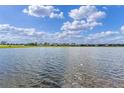 Picturesque lake view showcasing the neighborhood homes across the calm water, perfect for nature lovers at 6121 Blue Pond Way, St Cloud, FL 34771