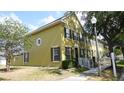 Well-maintained townhome featuring black shutters, attractive landscaping, and a charming architectural detail on the facade at 6258 Westcott Cove Blvd, Orlando, FL 32829