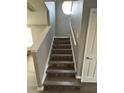 Elegant staircase featuring wood steps and white banisters at 6258 Westcott Cove Blvd, Orlando, FL 32829