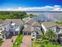 Beautiful, modern, two-story home with a well-kept lawn in a desirable neighborhood with lake access at 7398 Alpine Butterfly Ln, Orlando, FL 32819