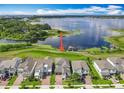 Beautiful, modern, two-story home with a well-kept lawn in a desirable neighborhood that backs up to a lake at 7398 Alpine Butterfly Ln, Orlando, FL 32819