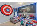 Playful bedroom featuring two beds, cartoon character decor and tile floors at 7905 Golden Pond Cir, Kissimmee, FL 34747