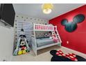 Whimsical bedroom featuring a bunk bed, Mickey Mouse decor and tile floors at 7905 Golden Pond Cir, Kissimmee, FL 34747