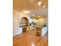 Open floor plan showcasing kitchen with white cabinets, appliances, granite counters and an adjacent built-in desk space at 860 N Orange Ave # 428, Orlando, FL 32801