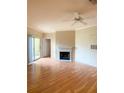 Living room featuring wood floors, sliding glass doors to the balcony, an air conditioner, and a fireplace at 860 N Orange Ave # 428, Orlando, FL 32801
