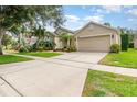 This charming home has mature landscaping and a two car garage at 10222 Marsh Pine Cir, Orlando, FL 32832