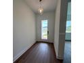 Bright entryway with wood-look flooring, modern light fixture, and glass front door offers a welcoming entrance at 1043 Gloryland Ct, Sanford, FL 32771